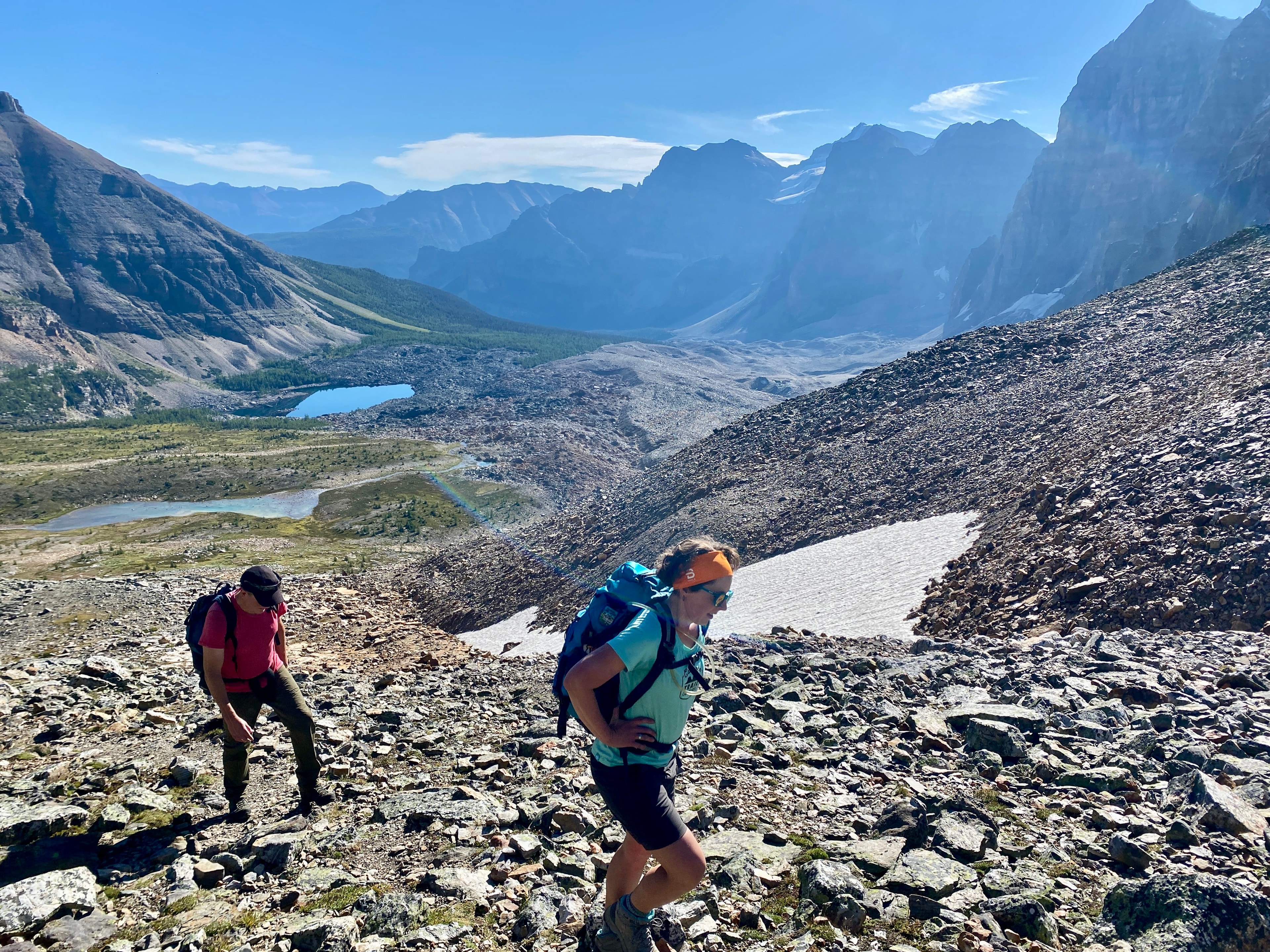 Two hikers ascending a rocky alpine slope in the Canadian Rockies