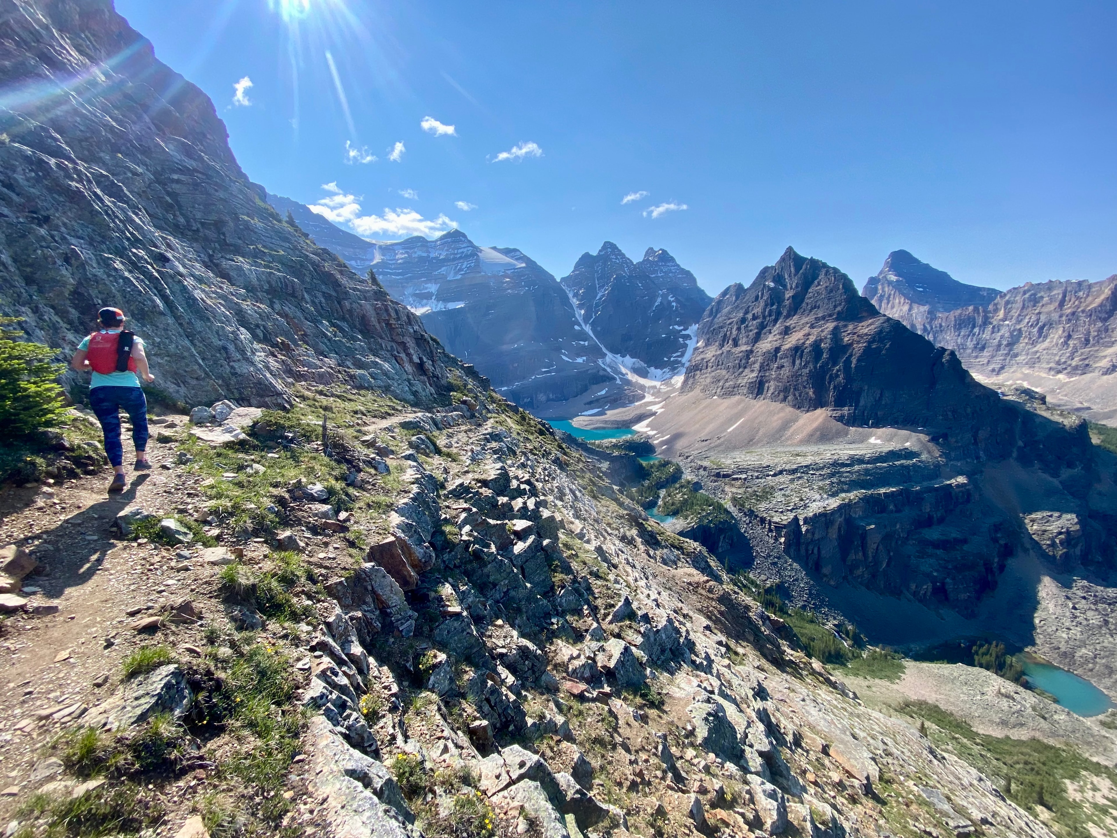 Runner on a ridge above turquoise alpine lakes, Canadian Rockies
